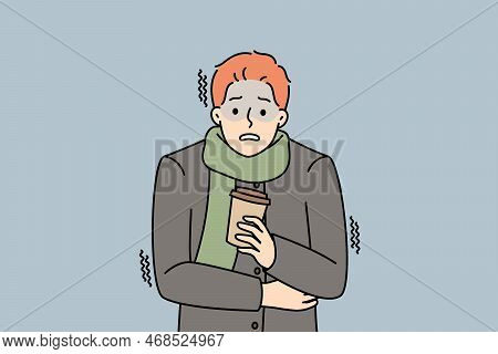 Unhappy Young Man In Outerwear Hold Takeaway Coffee Freezing Outdoors. Distressed Guy With Warm Drin