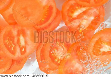 Close-up Fresh Slices Of Tomato On White Background. Slices Of Tomato In Sparkling Water On White Ba