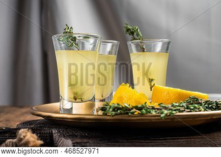 Limoncello Shots, Italian Lemon Liqueur. Wooden Background. Top View.