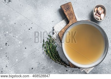 Bone Meat Chicken Broth In A Plate. Gray Background. Top View. Copy Space.