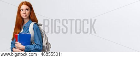 Creative And Thoughtful Cute Daring Foxy Girl With Red Hair, Hold Backpack And Notebooks, Biting Lip