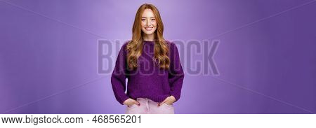 Optimistic Attractive Ginger Girl In 20s Wearing Purple Sweater Standing Ready And Energized Over Vi
