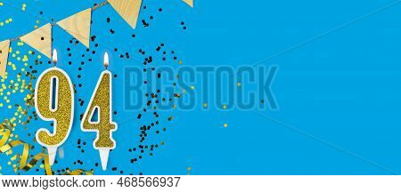 Golden Candle Number Ninety Four. Birthday Or Anniversary Card With The Inscription 94 On Blue Backg