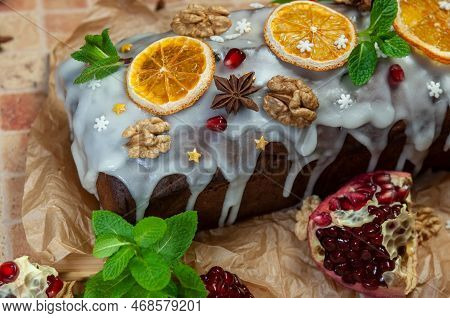 Christmas Stollen With Candied Fruit And Dried Fruits On Parchment. Stollen - Traditional German Bre