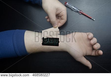 Robot Arm Concept. Man Shows Biomechanical Prosthetic Hand. Guy Repairs His Hand With Tool. Bioengin