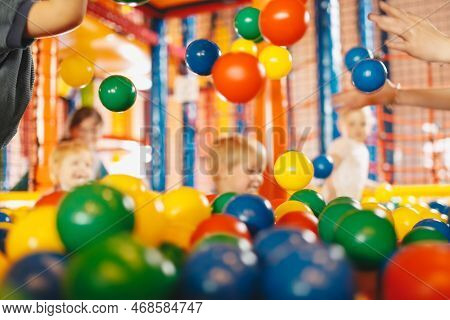 School Children Having Fun In Indoor Park Playground. Happy Boy Playing At Balls Pool Playground. Bo