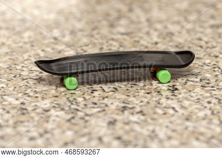 A Fingerboard On A Neutral Blurred Background Of A Marble Surface, Close-up, Selective Focus. A Skat