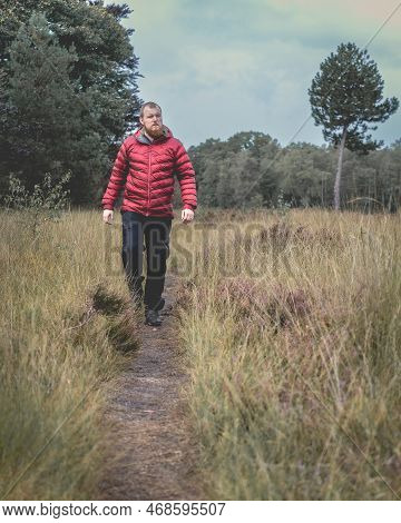 Guy With A Red Jacket Hiking In The Forest. Elspeet, Netherlands, 28 September 2022