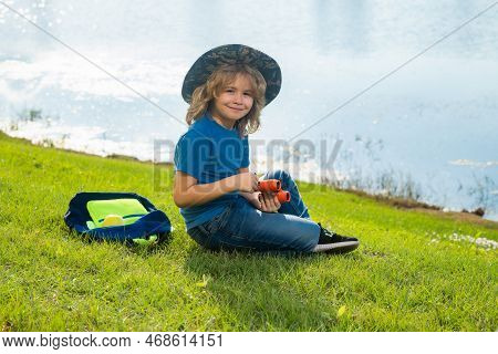Scout Boy Wearing Explorer Hat And Backpack Outdoor. Explorer And Adventure With Binocular.
