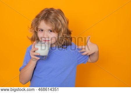 Kid Drink Milk With Funny Emotions On Yellow Background. Child Drinking Milk, Studio Portrait. Cute 