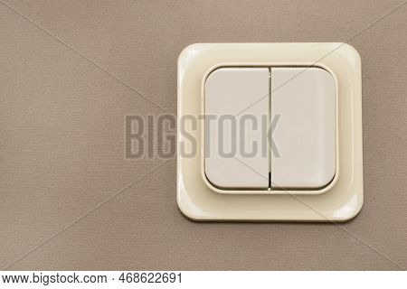 Plastic Light Switch On Brown Wall Closeup