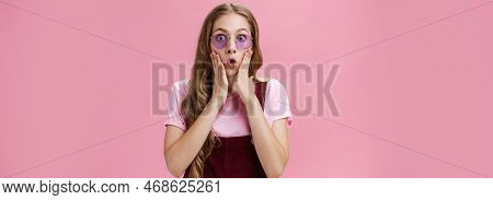 Waist-up Shot Of Sylish Young Girl With Tattoo And Wavy Pretty Natural Hairstyle Pressing Palms To C