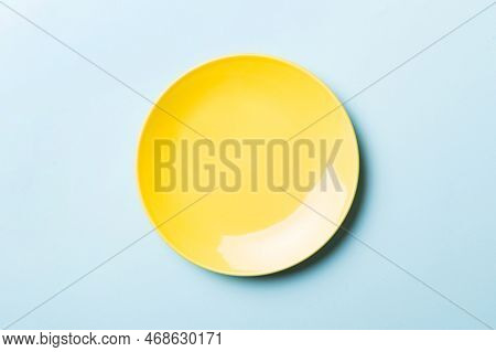 Top View Of Isolated Of Colored Background Empty Round Yellow Plate For Food. Empty Dish With Space 
