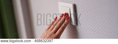 Woman Hand Presses White Light Switch. Stylish Modern Wall Switch Concept