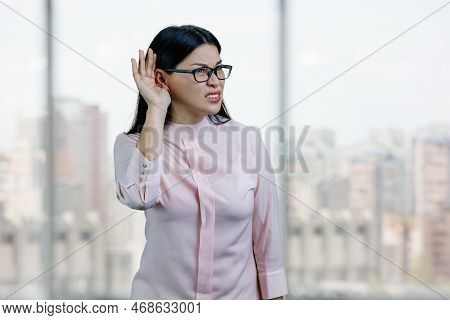 Young Asian Business Woman Try To Hear You Out.overhear Listening Sound To Gossip. Checkered Windows