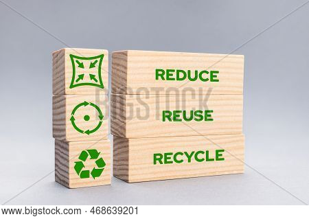 Reduce Reuse Recycle Icons And Words On Wooden Blocks On Gray Background