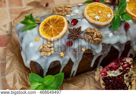 Christmas Stollen With Candied Fruit And Dried Fruits On Parchment. Stollen - Traditional German Bre