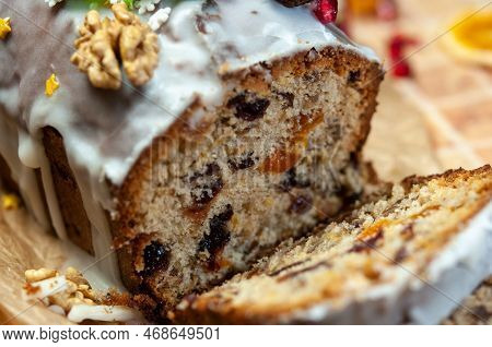 Christmas Stollen With Candied Fruit And Dried Fruits On Parchment. Stollen - Traditional German Bre