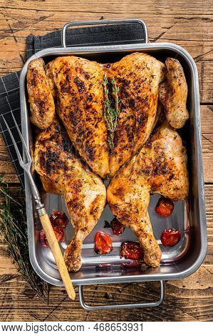 Homemade Chicken Rotisserie With Thyme In Baking Dish. Wooden Background. Top View.
