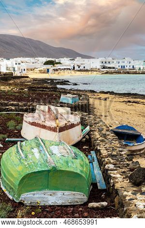 La Graciosa Landscape - Colorful Boats On A Shore And White Architecture Of Caleta Del Sebo,  Spain