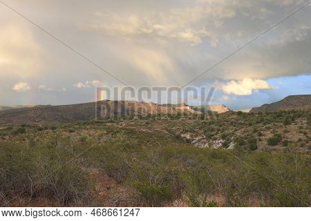 A Beautiful Rainbow Over The Desert Landscape, Coconino National Forest, Yavapai County, Arizona.
