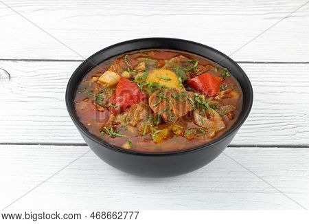 Khashlama Stew Of Beef Or Lamb Meat With Vegetables On A Black Plate, Top View. Armenian And Georgia