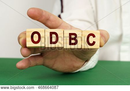 In The Man's Hand Are Cubes With The Inscription - Odbc.