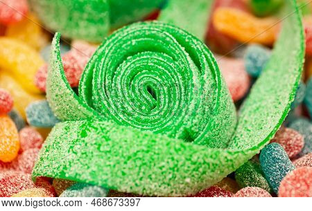 Close-up, Background With Green Rolled Gummies Coated With Sugar.
