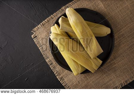Tamales De Elote, Also Called Uchepos. Typical Mexican Dish. Can Be Served With Green Salsa And Acco