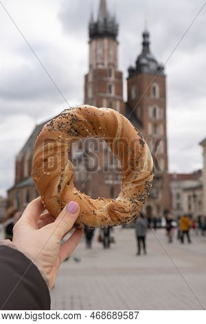 Tourist Woman Eating Bagel Obwarzanek Traditional Polish Cuisine Snack Waling On Market Square St. M