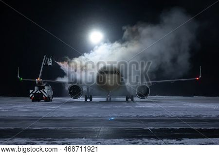 Ground Deicing Of A Passenger Aircraft On The Night Airport Apron At Winter