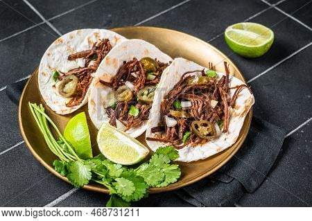 Mexican Beef Barbacoa Tacos With Cilantro And Onion. Black Background. Top View