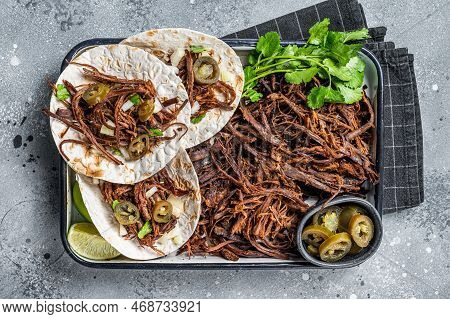 Cooking Of Mexican Lamb Barbacoa Tacos With Cilantro And Onion. Gray Background. Top View