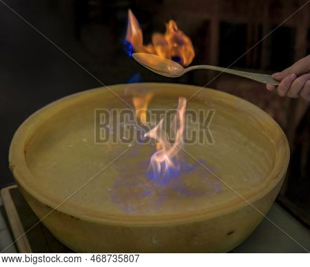 Flambe Of Italian Brandy Lit On Fire In A Pecorino Wheel To Soften The Cheese Tableside For Pasta Sa
