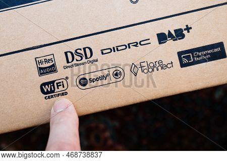 Paris, France - Dec 13, 2022: Pov Male Hand Pointing To Wi Fi Certified Sign On New Onkyo Ns-6170 Ne