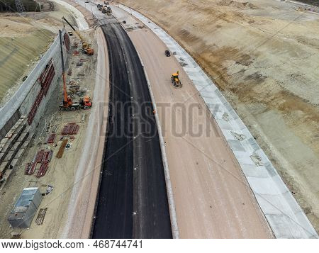 Mountain Road Constraction. Workers Reinforce The Slope Over The New Road. Road Construction In Prog