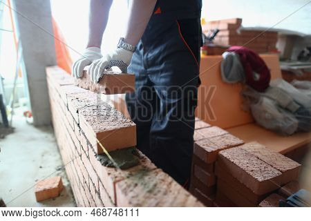 Construction Mason Builds Brick Wall In Apartment. Construction Of Brick Walls And Partitions In Apa