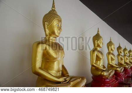 Golden Buddha Images Lined Up At Wat Sothon Wararam Worawihan, Chachoengsao Province