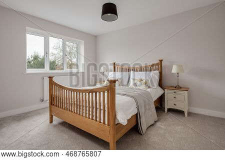 Cambridge, England - March 1 2019: Luxury Modern Bright Contemporary Furnished Bedroom With Pine Dou