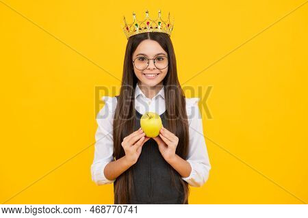 Teen Child In Queen Crown Hold Apple Isolated On Yellow Background. Princess Girl In Tiara. Teenage 