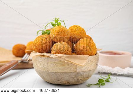 Bowl Of Delicious Fried Tofu Balls With Pea Sprouts On White Tiled Table