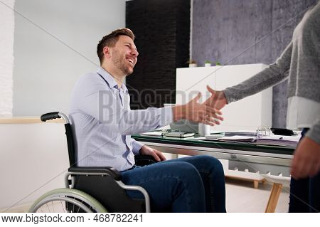 Business Person In Wheel Chair Shaking Hands