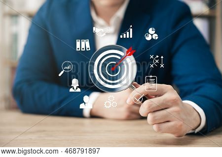 Businessman Showing Magnifying Glass Focusing On Goal Icon, Corporate Development And Global Busines