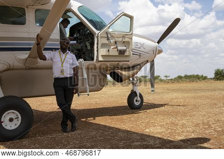 Serengeti, Tanzania - October 14th, 2022: A Pilot Standing Next To His Light Airplane In An Airstrip