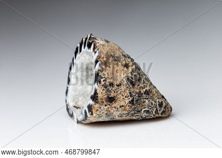 Agate Geode With Hyaline Quartz Crystals On Grey Background. A Cross Section Of Pure, Clear Or Color