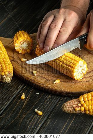 The Cook Cuts The Maize With A Knife. Corn Is An Excellent Dietary Breakfast Or Lunch. Working Envir