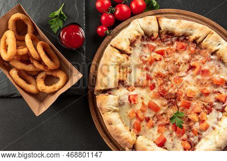 Indian Flatbread Pizza Delivery On Dark Background. Indian Pizza On A Dark Background With Snacks. I