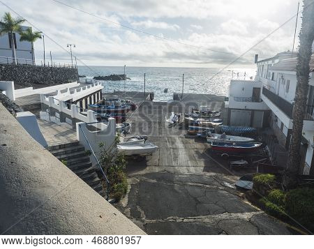Alcala, Tenerife, Canary Islands, Spain, December 20, 2021: Cocrete Pier With Docked Fishing Boats, 