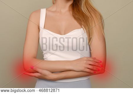 Young Woman Experiencing Pain In Elbow Joint