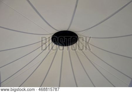 White Tarpaulin Taut, Shading From The Sun And Rain Over The Terrace Of The Restaurant, On The Playg